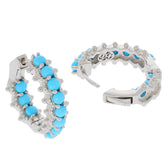 Round blue turquoise sterling silver earrings featuring a sparkling gemstone and elegant design.